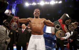 Anthony Joshua holding its belts